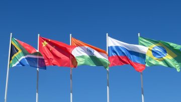 Waving,Flags,Of,The,Brics,Countries,Against,The,Blue,Sky.