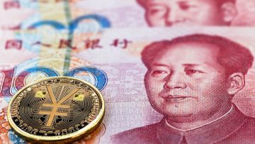 one hundred yuan banknotes, next to an e-RMB gold coin, digital version of the yuan. Concept of new digital currency of the popular republic of china