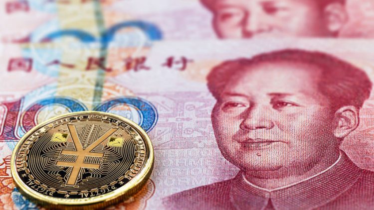 one hundred yuan banknotes, next to an e-RMB gold coin, digital version of the yuan. Concept of new digital currency of the popular republic of china