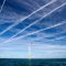Contrails over  wind turbines in the Walney offshore wind farm.