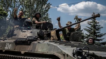 Ukrainian service members ride a BMP-1 infantry fighting vehicle near the front line city of Bakhmut