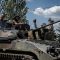 Ukrainian service members ride a BMP-1 infantry fighting vehicle near the front line city of Bakhmut