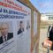 A man walks past an information board with portraits of Russian presidential candidates in the upcoming election in Yevpatoriya